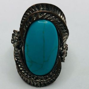 Turquoise ring with a unique design around the ring